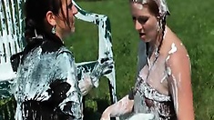 These beautiful women in their black blouses and miniskirts have plenty of whipped cream to spray all over each other out in the field, and being as experienced as they are in all things messy, they really know how to work it in sensually, getting the mos