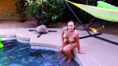 Busty babe Lulu sunbathes naked by the pool and then jumps in